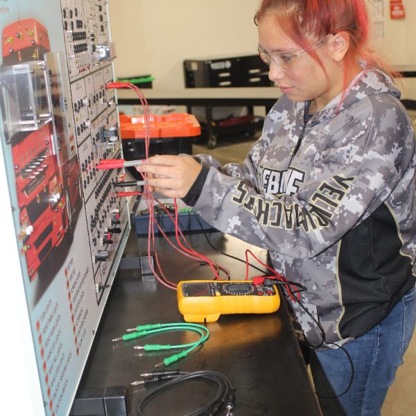  Photo of student using electronic trainer board